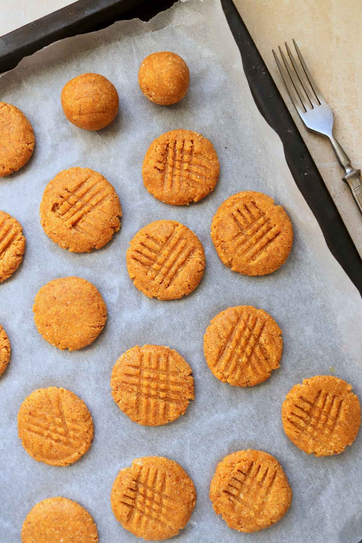 Unbaked cookies on a baking sheet lined with parchment paper.