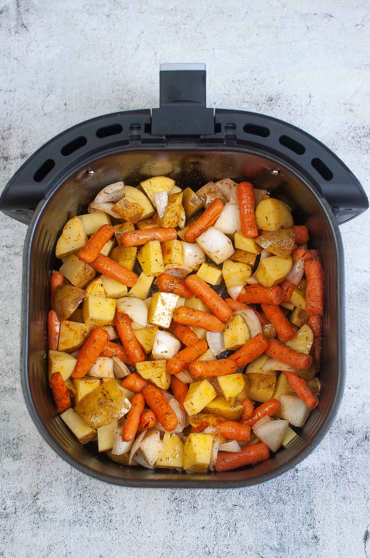 Vegetables in the air fryer basket.