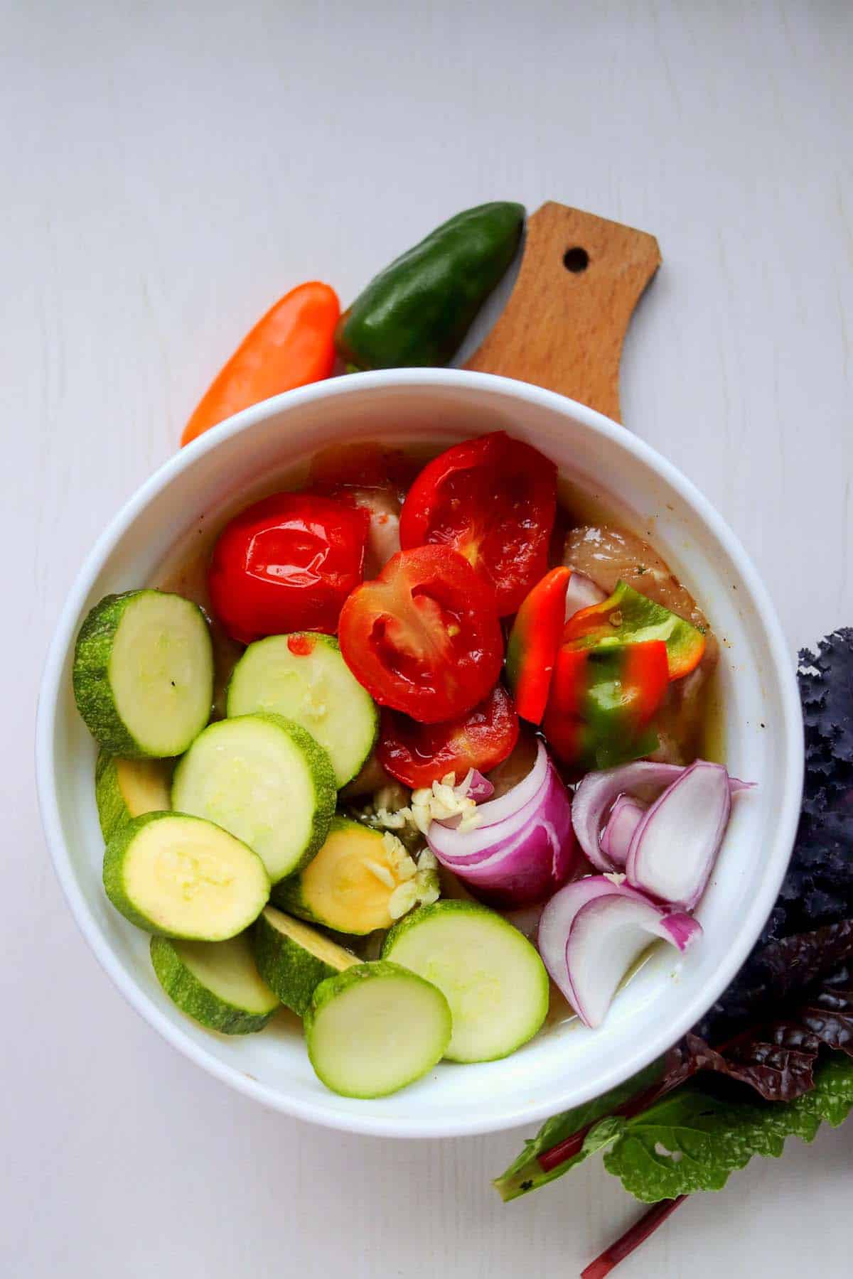The sliced vegetables in the marinade.
