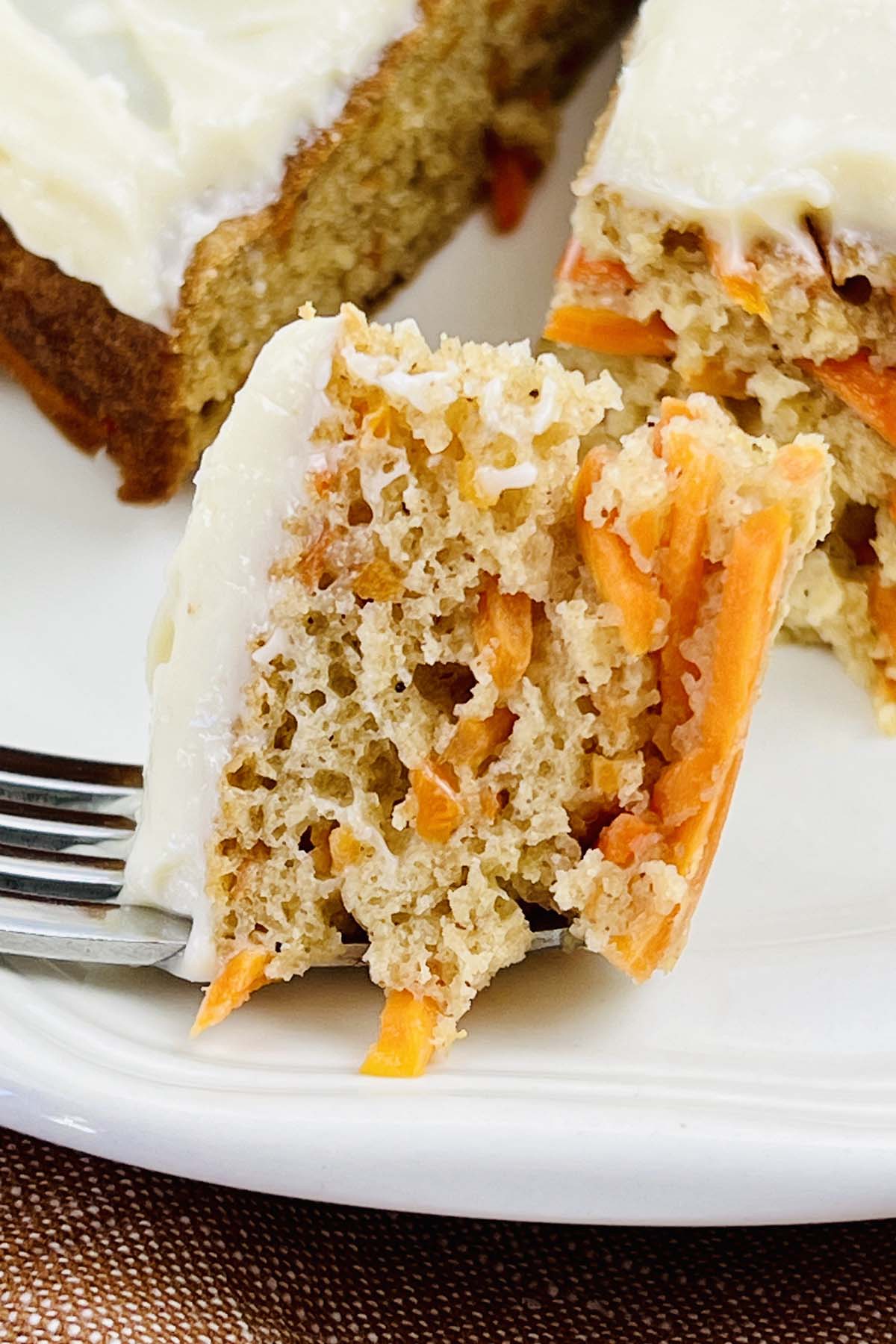 A piece of carrot cake on a fork.