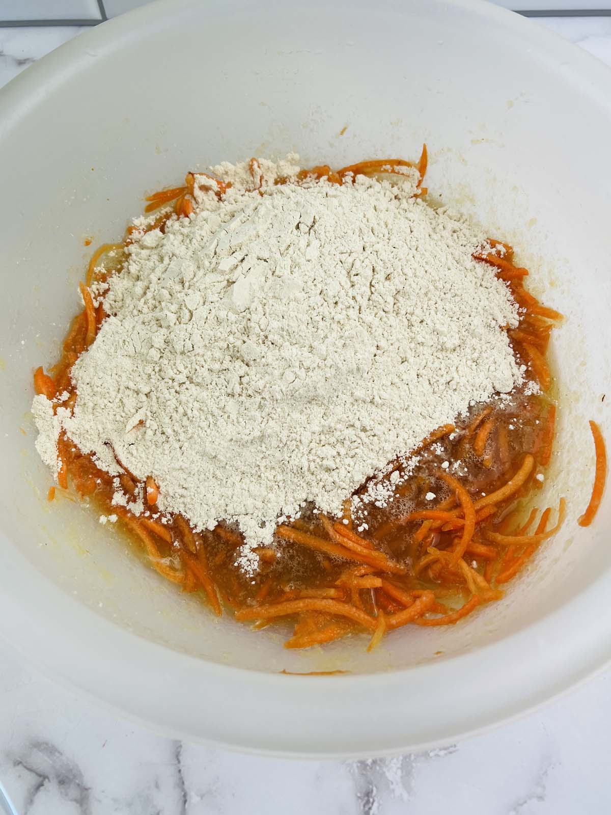 The flour mixture on top of the carrot mixture.