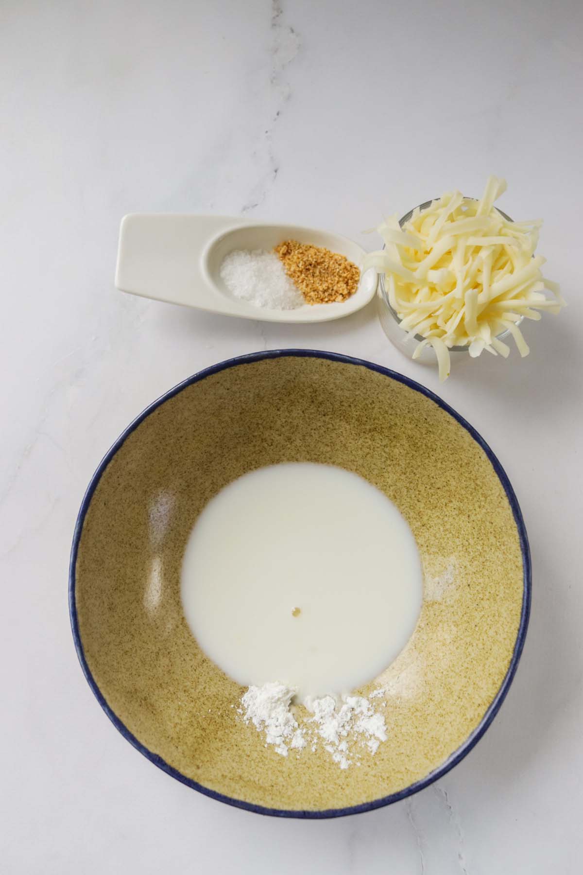 Milk and cornstarch in a bowl.