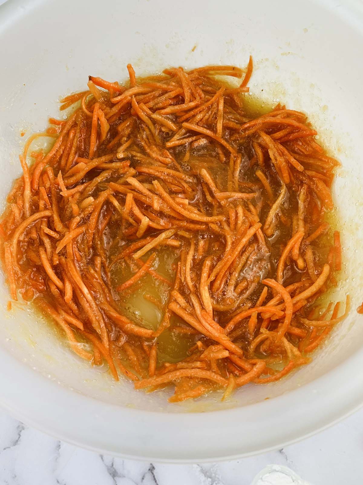 Shredded carrots and applesauce mixed together.