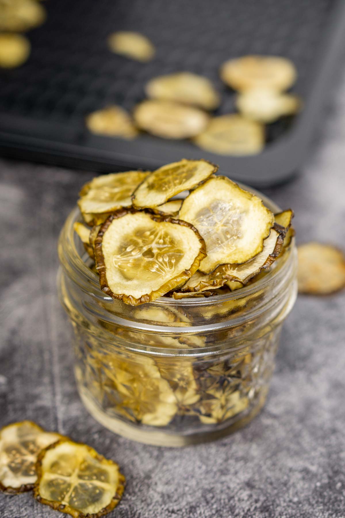 Dehydrated pickle chips snack in a glass jar