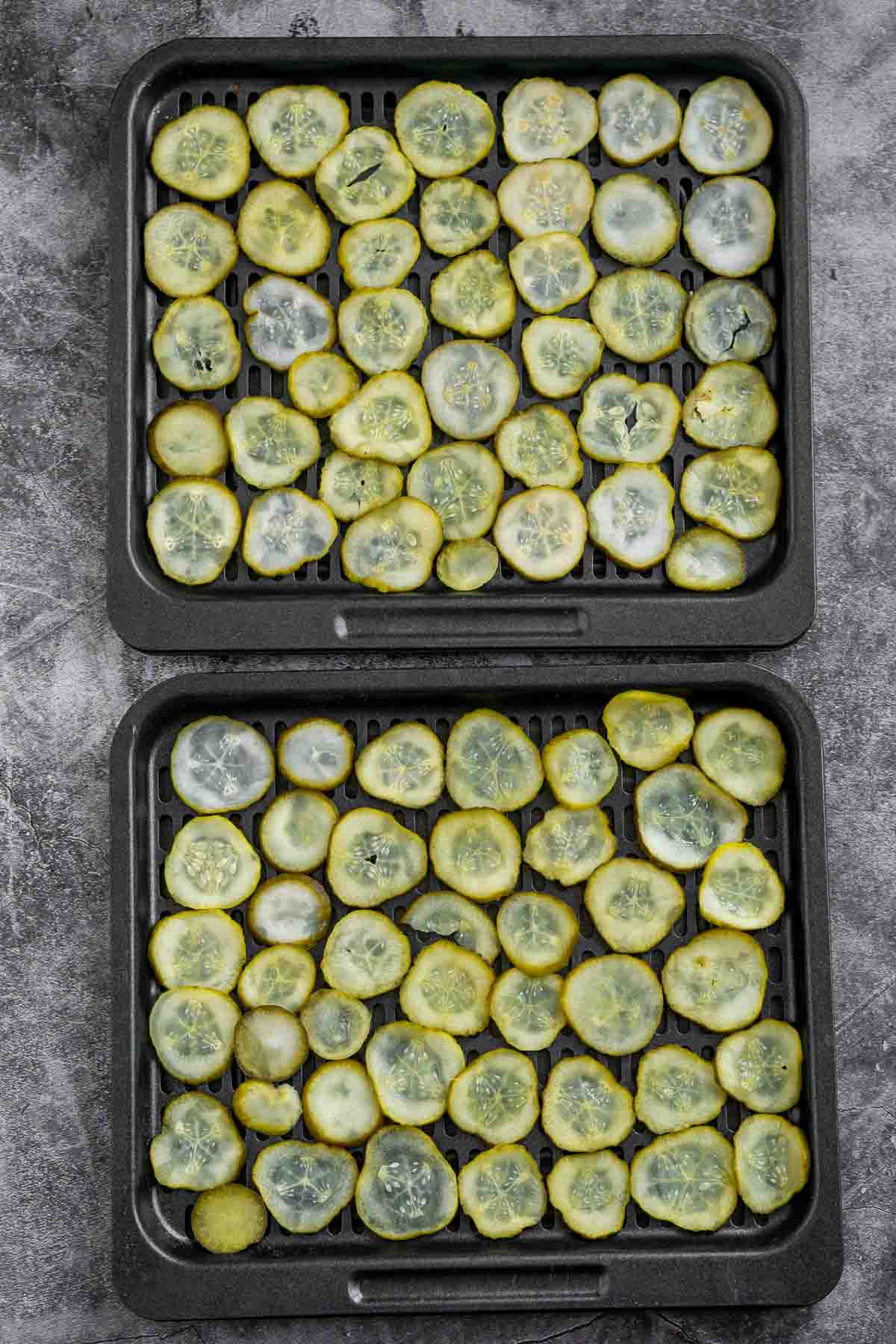 Sliced pickles arranged on an air fryer tray