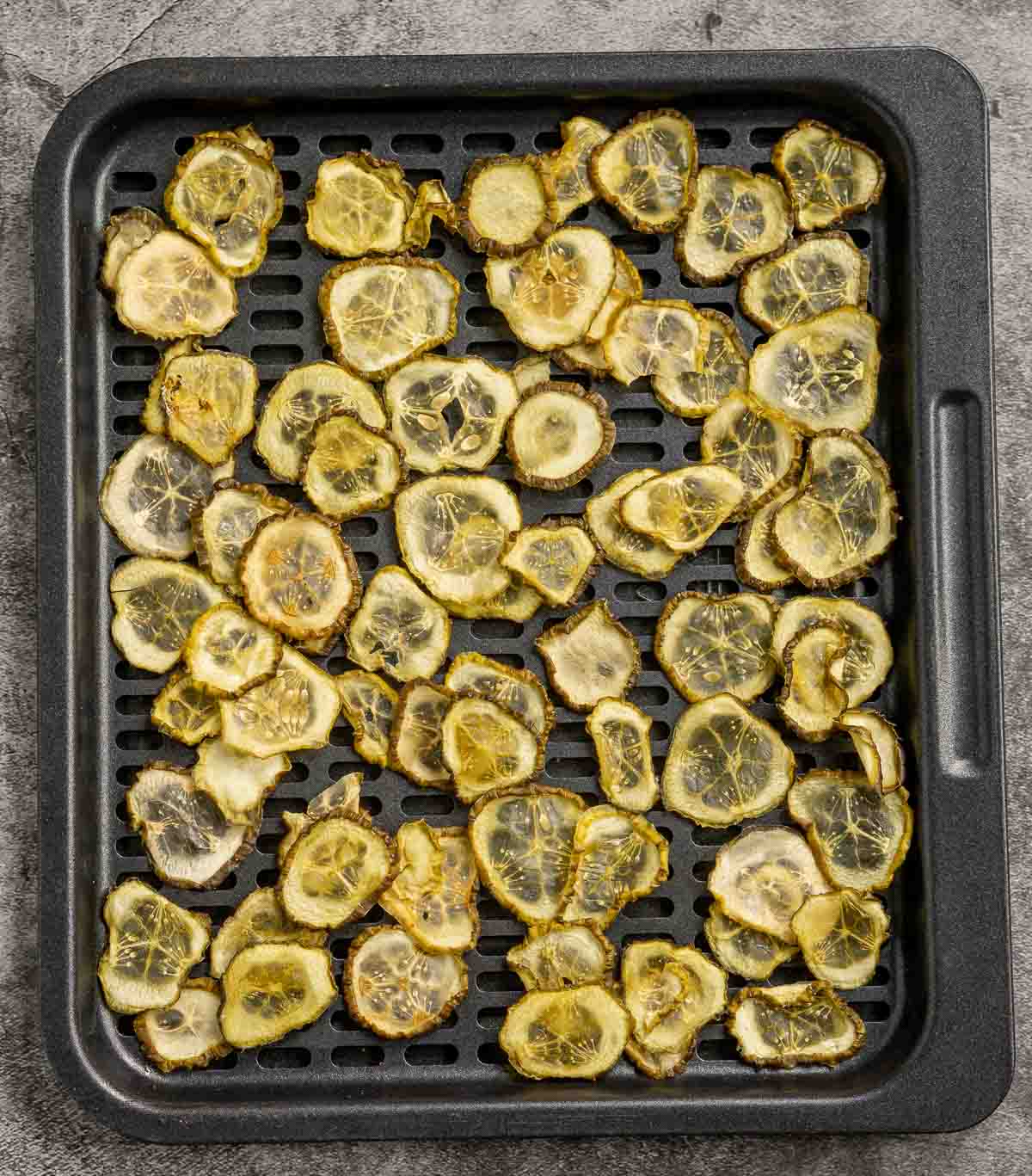 Dehydrated pickles on an air fryer tray